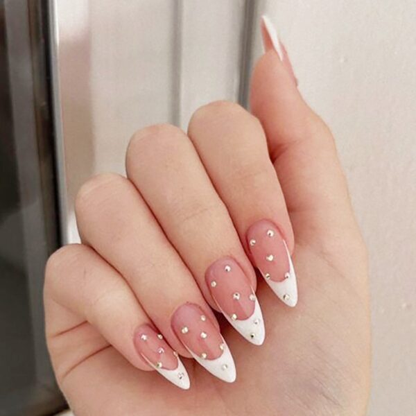 French nails with nude pink almond tips and rhinestones