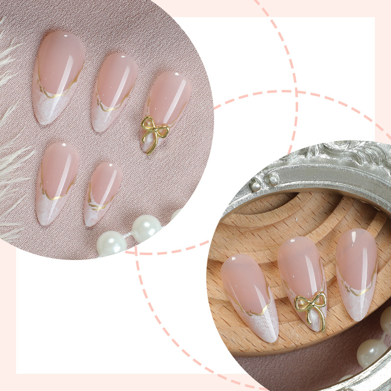 Nude white bridal press on nails with gold bow and lace detail