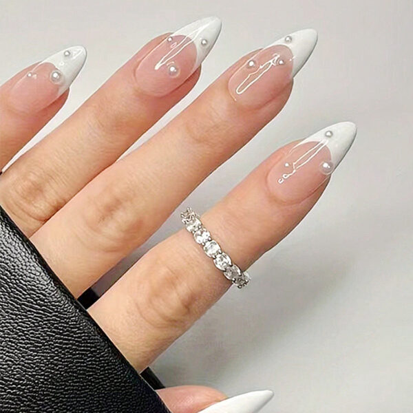 White pearl French nails with nude pink almond tips