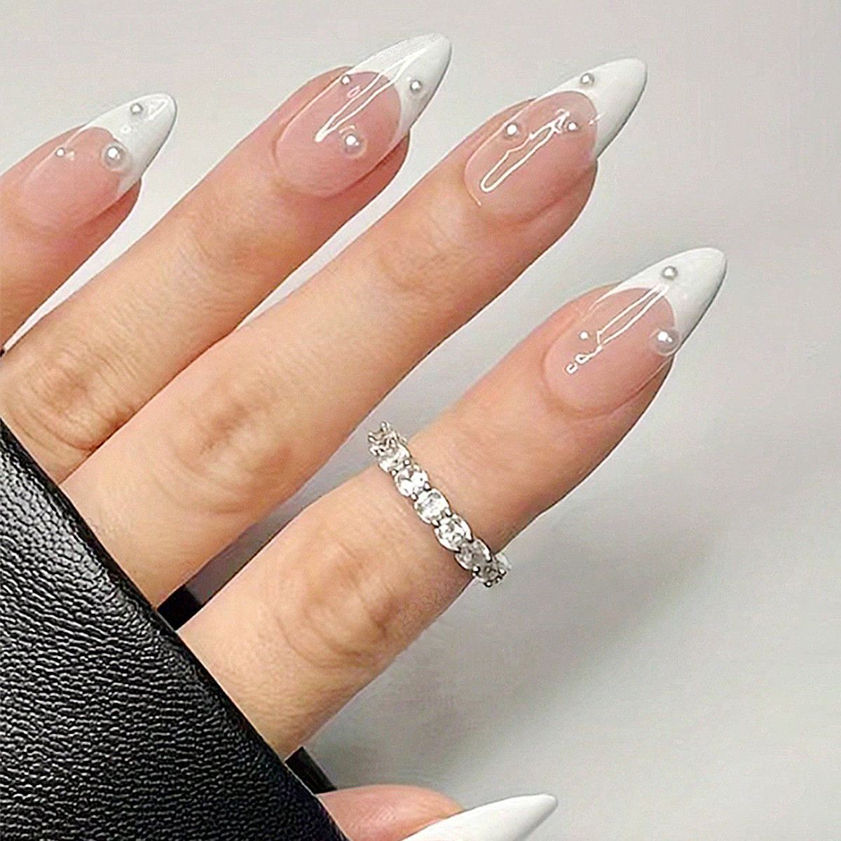 White pearl French nails with nude pink almond tips