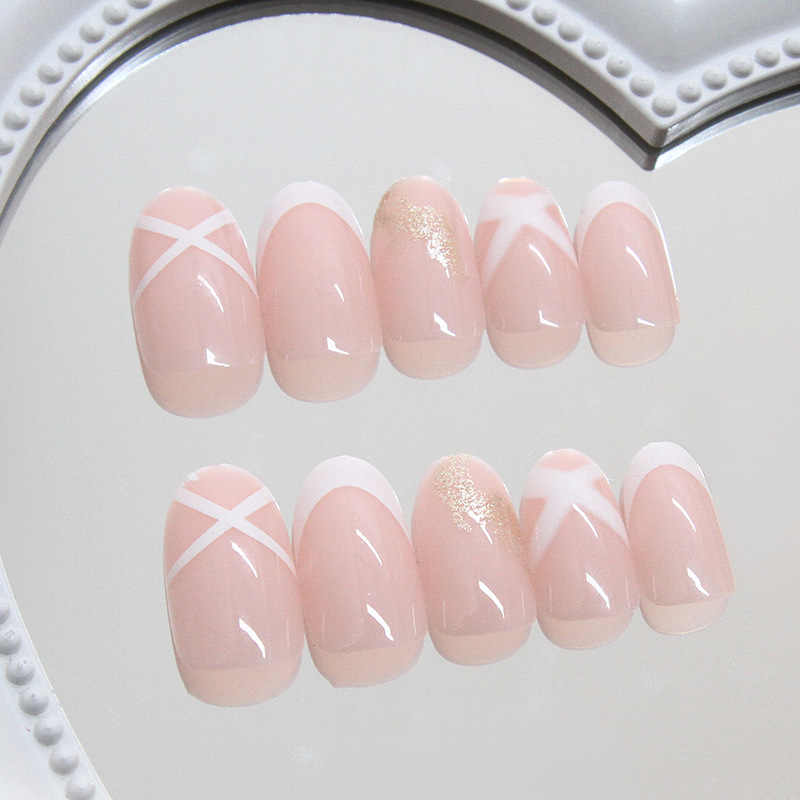 Pink white French swirl nails with glitter press on nail accents