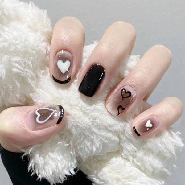 Press On Nails with black heart nail art and black tips