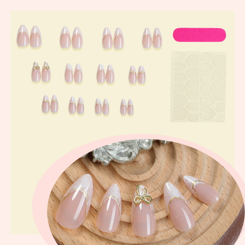 Nude white bridal press on nails with gold bow and lace detail