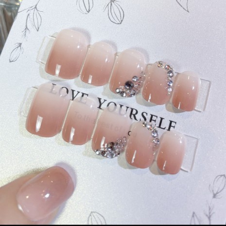 Nude pink 3D press on nails with rhinestone bow accents