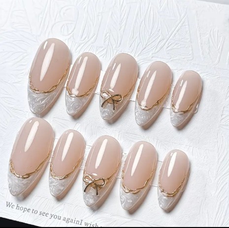 Nude white bridal press on nails with gold bow and lace detail